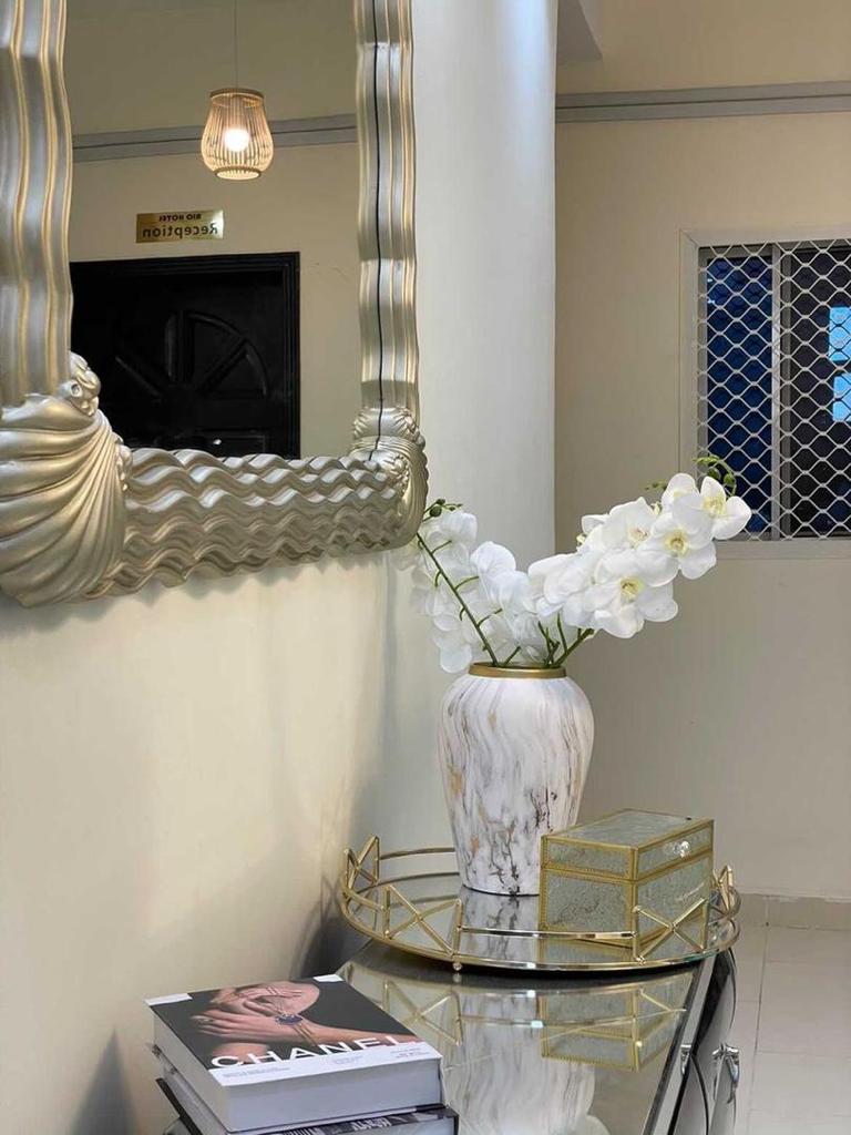 Lobby mirror, flowers and console at Rio Hotel